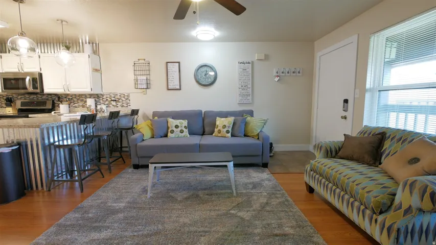 Open concept living area with wood-finish flooring