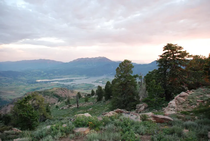 Expansive mountainous terrain with multiple lakes and distant valleys
