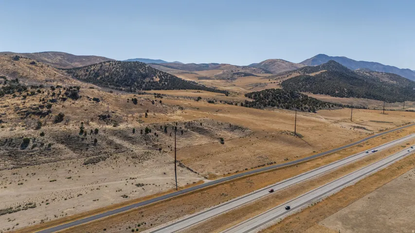 Expansive desert landscape with distant mountains and a multi-lane highway