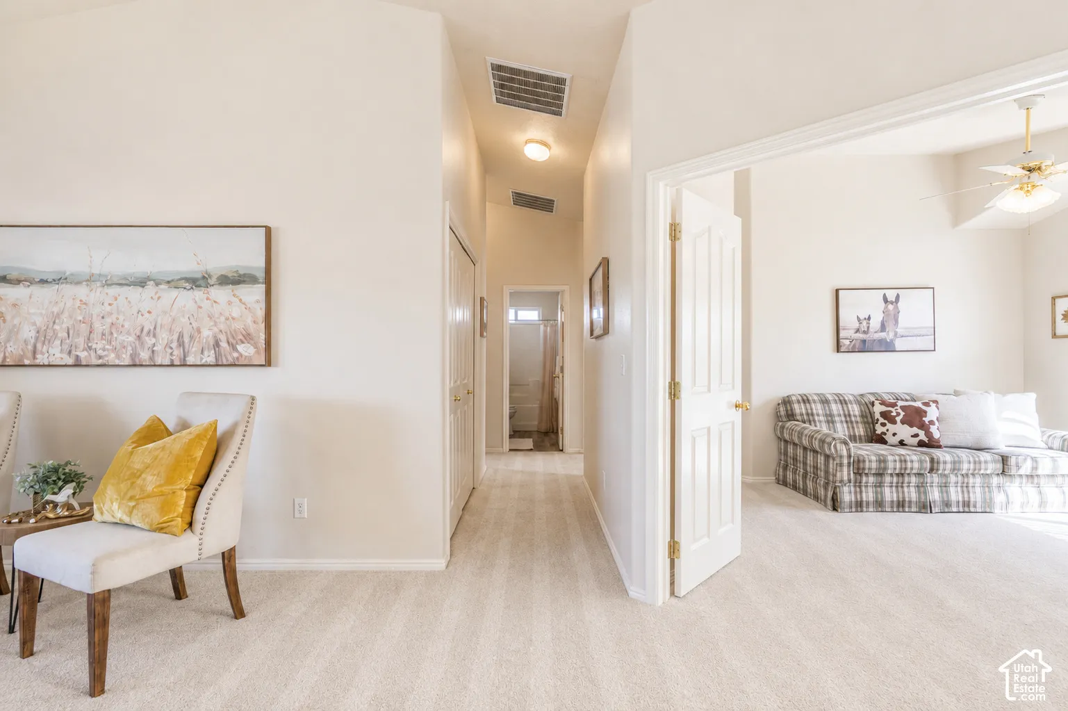 Vaulted ceilings, neutral wall tones, and light-toned carpet flooring create an inviting atmosphere