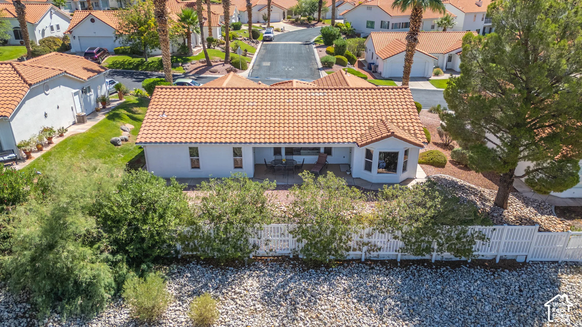 White stucco exterior with a terra cotta tile roof