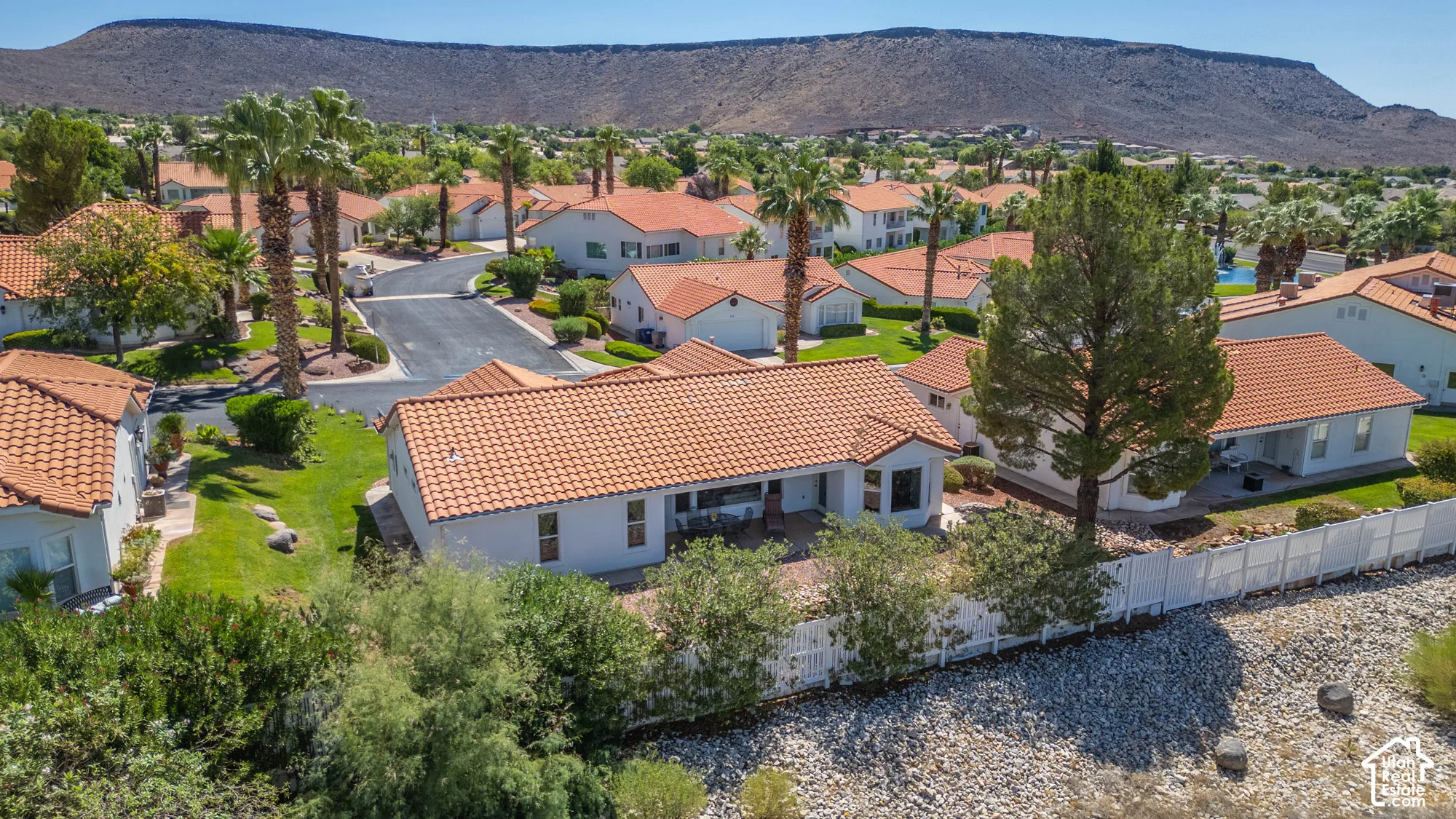 White stucco exterior with a terracotta tile roof