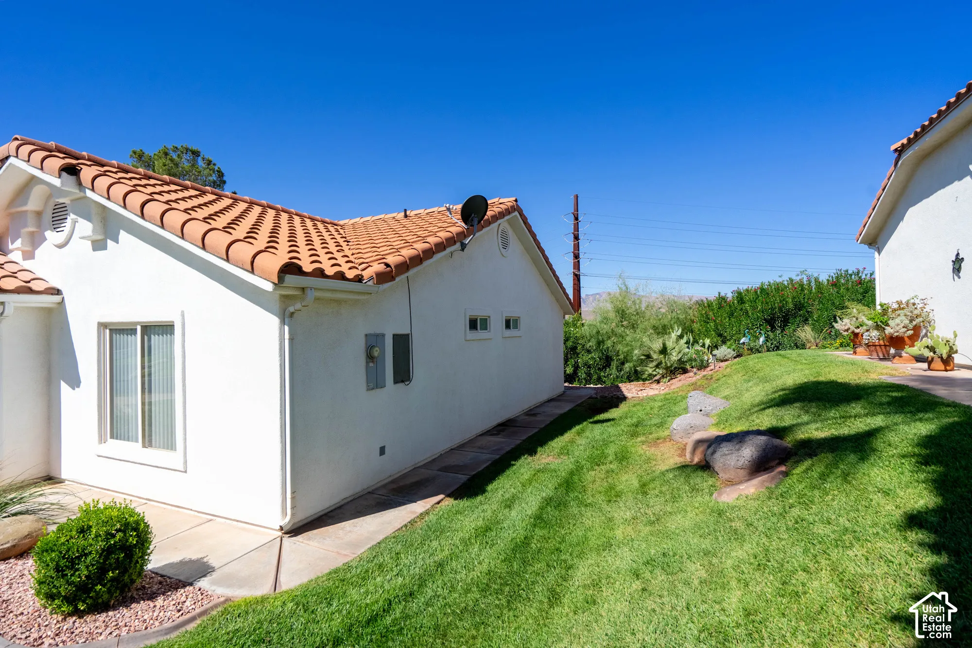 White stucco exterior with a terra cotta tile roof