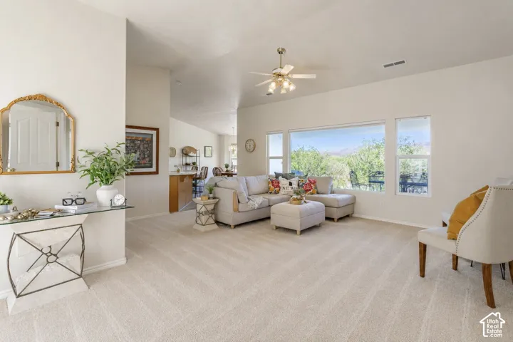 Spacious living area with vaulted ceilings, recessed lighting, and expansive windows