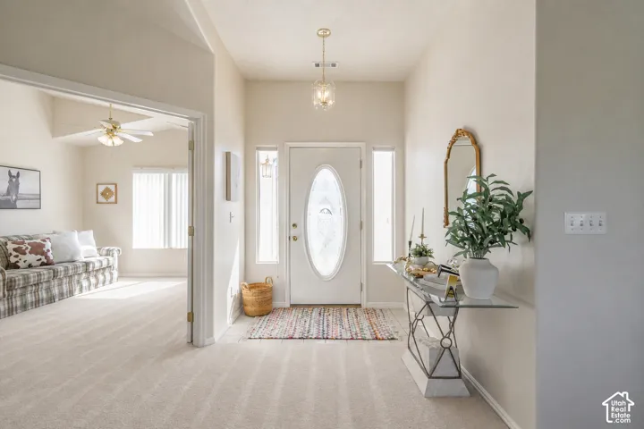 Front entry with an oval-paneled door, two sidelight windows, and a hanging pendant light