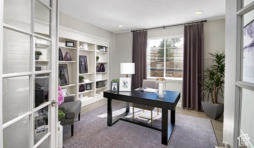 French doors with frosted glass panels, built-in shelving, recessed lighting, window with exterior landscape, and light-toned flooring