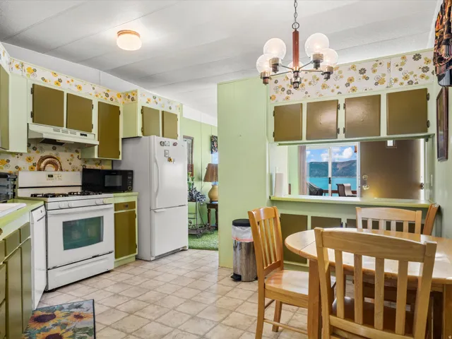Kitchen featuring an oven range, refrigerator, microwave, and ample cabinetry