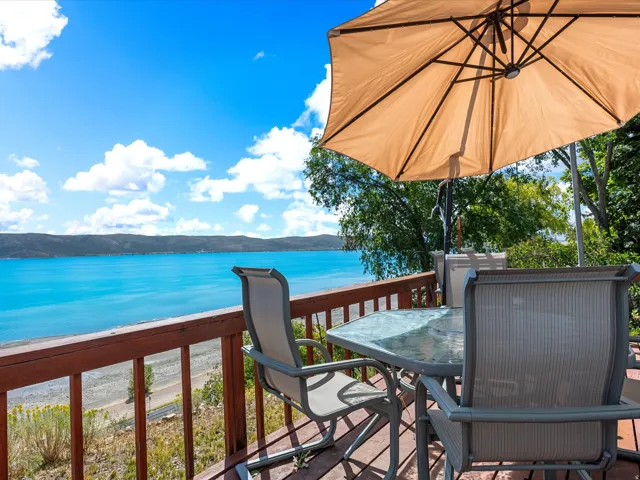 Deck with wood railing overlooking a body of water