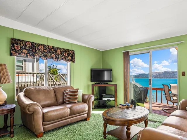 Living area with light green walls and a white paneled ceiling