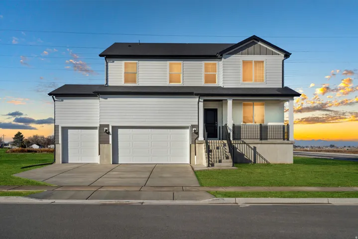 Two-story dwelling featuring white horizontal siding and dark trim