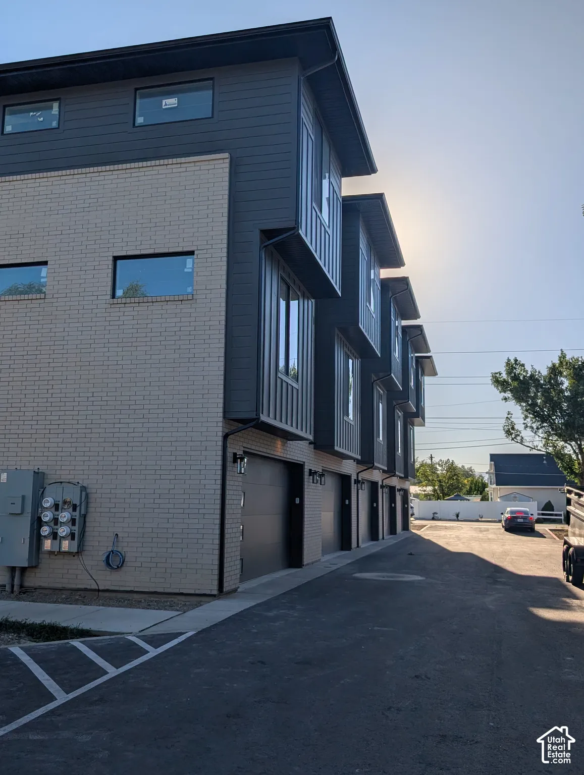Modern townhome exteriors featuring dark siding and light brick accents