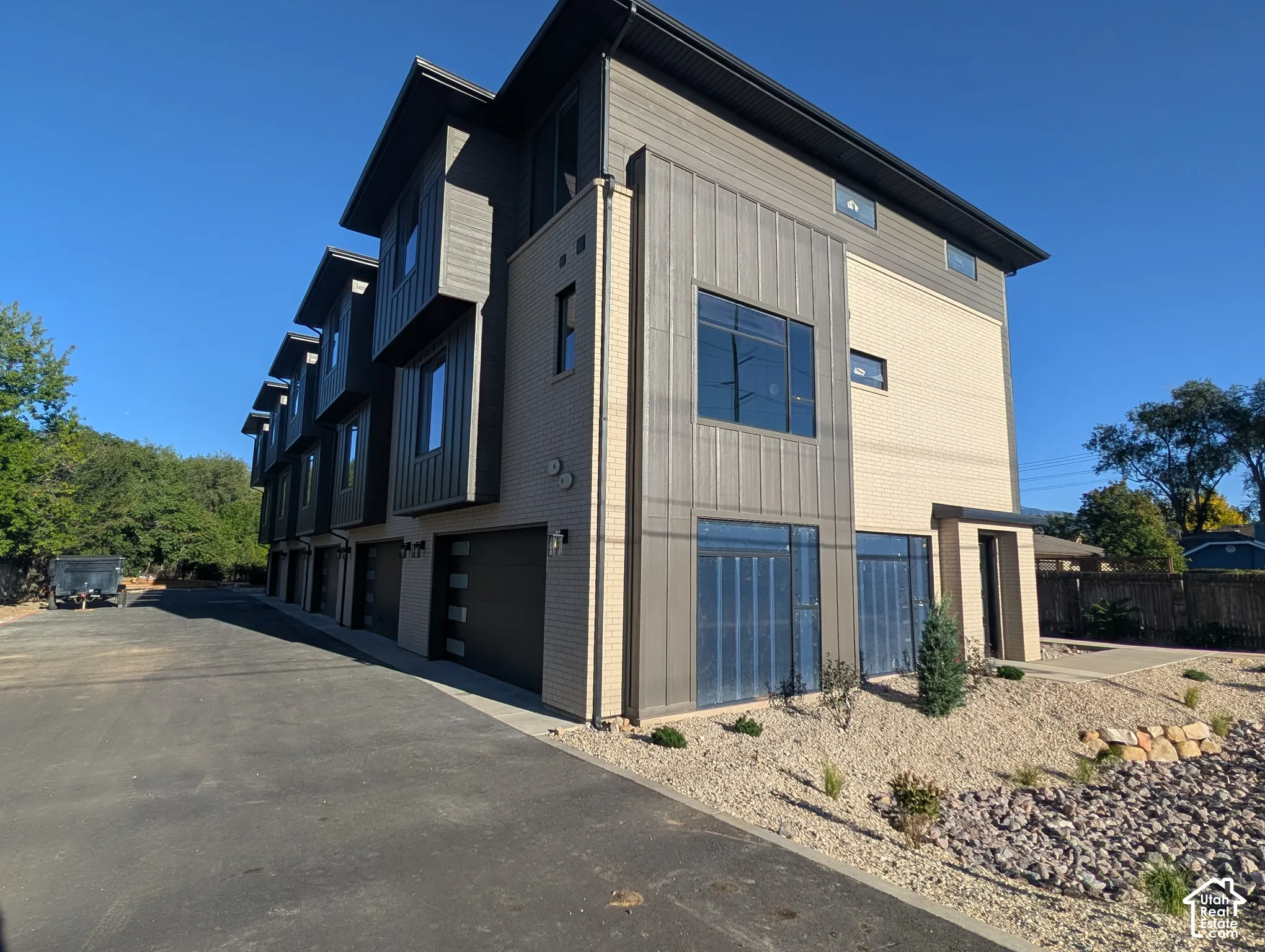 Contemporary multi-story exterior featuring a combination of brick and vertical siding