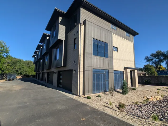 Contemporary multi-story exterior featuring a combination of brick and vertical siding