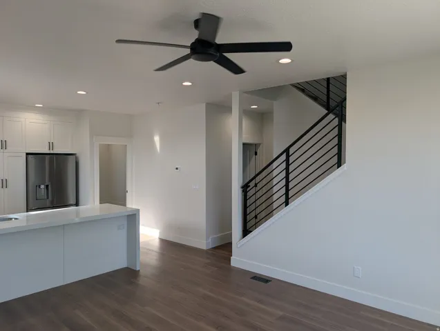 Wood-finish flooring, recessed lighting, and a modern ceiling fan
