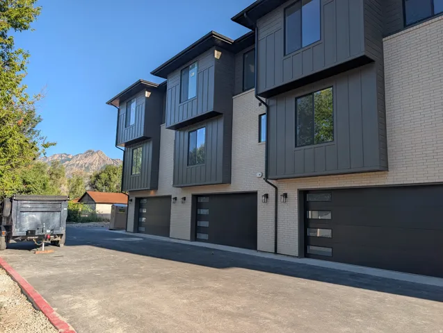 Contemporary multi-level exterior with light brick and dark paneling
