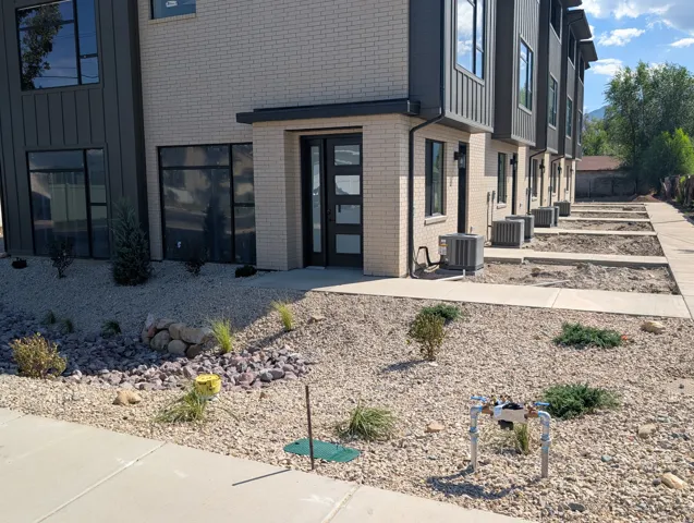 Modern exterior featuring light brick and vertical panel siding