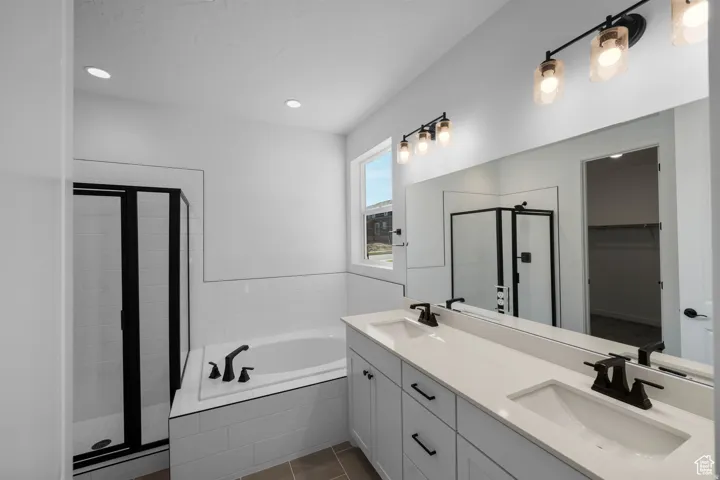 Dual vanity with white countertops, undermount sinks, and matte black faucets