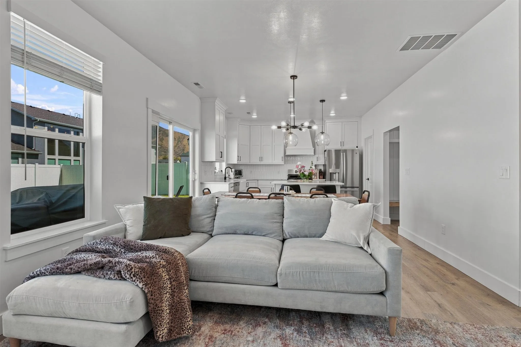 Open-concept design featuring wood-finish flooring, white walls, and recessed lighting