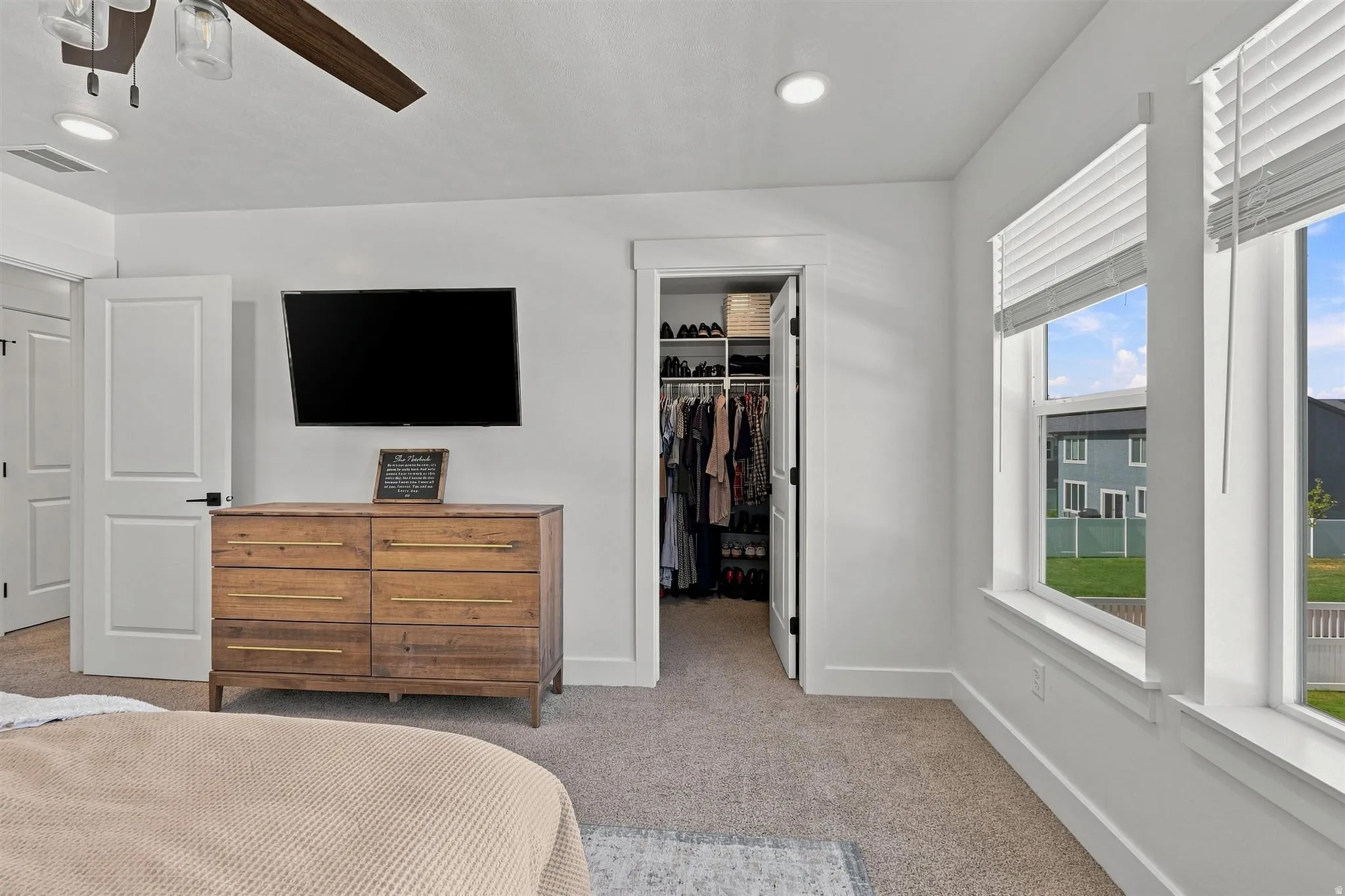 Plush carpeting, recessed lighting, and a ceiling fan with light kit