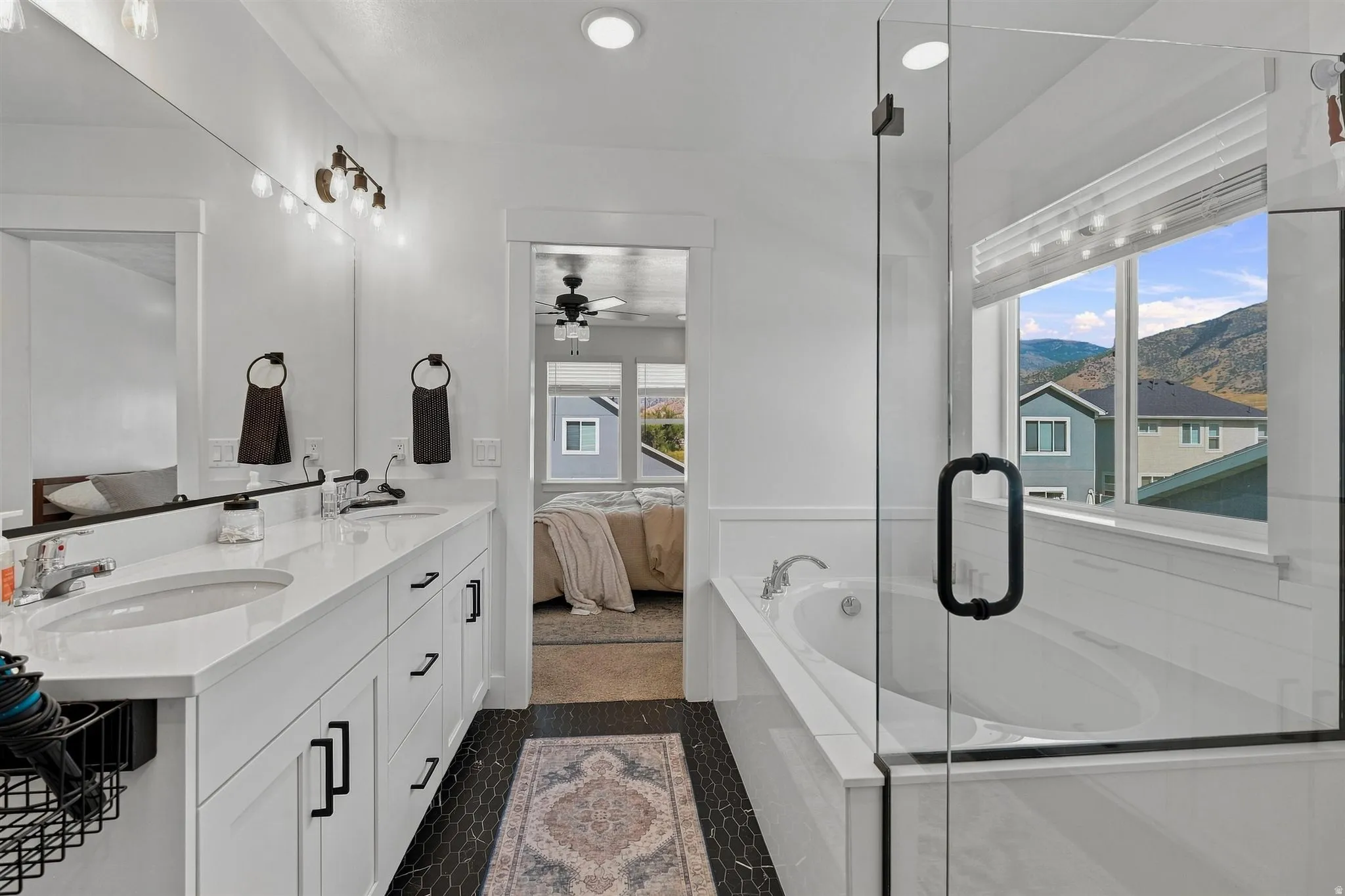 Dual-sink vanity with white countertops, undermount sinks, and matte black hardware