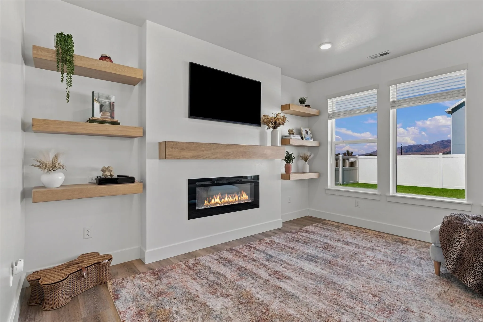 Contemporary fireplace with a wood-finish mantel and built-in shelving