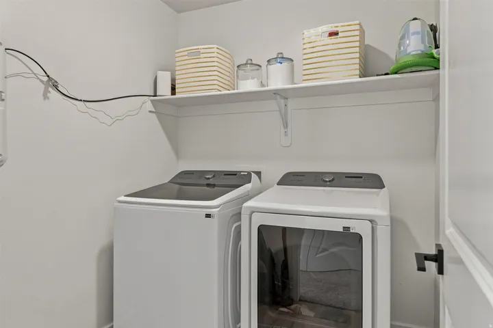 White laundry appliances with a top-load washer and front-load dryer