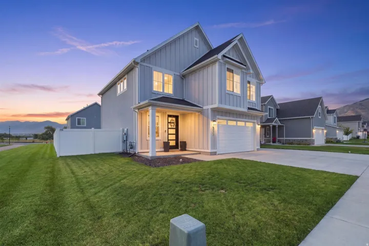 Modern two-story residence featuring light gray siding and board-and-batten accents