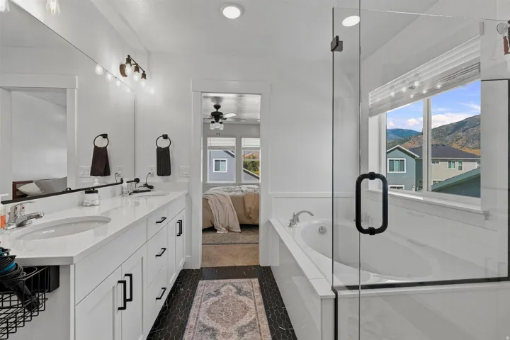 Dual-sink vanity with white countertops, undermount sinks, and matte black hardware
