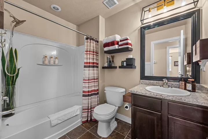Built-in bathtub with integrated shelving and shower fixture