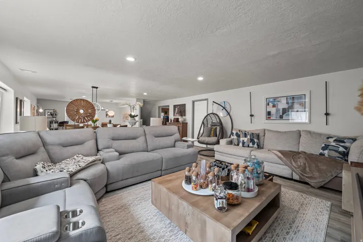 Recessed lighting, wood-finish flooring, white walls, and an open-concept layout