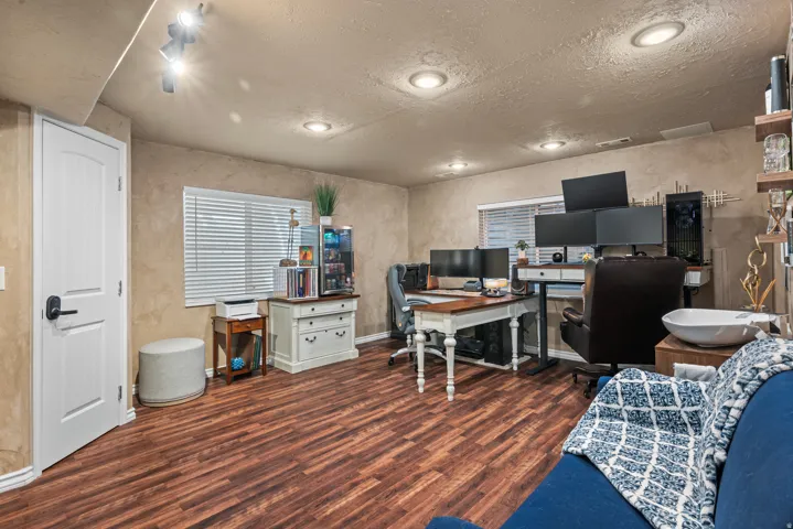 Wood-finish flooring, recessed lighting, and track lighting fixtures