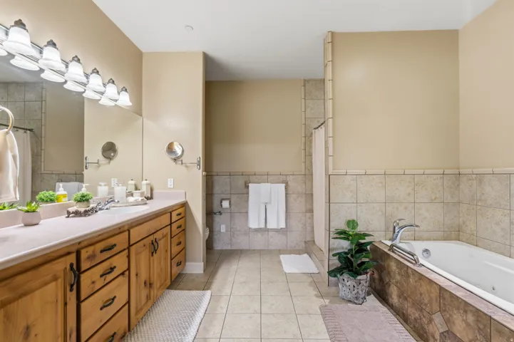 Dual vanity with wood cabinetry and an integrated countertop
