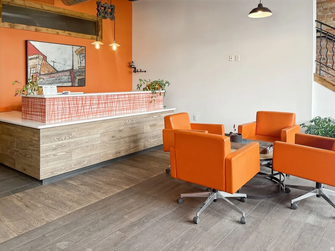 Built-in reception desk with a white countertop and wood-finish base