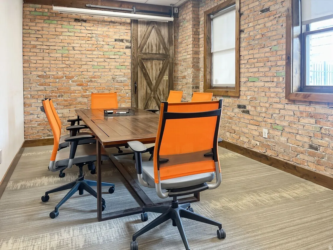 Exposed brick walls complement the wood-finish flooring