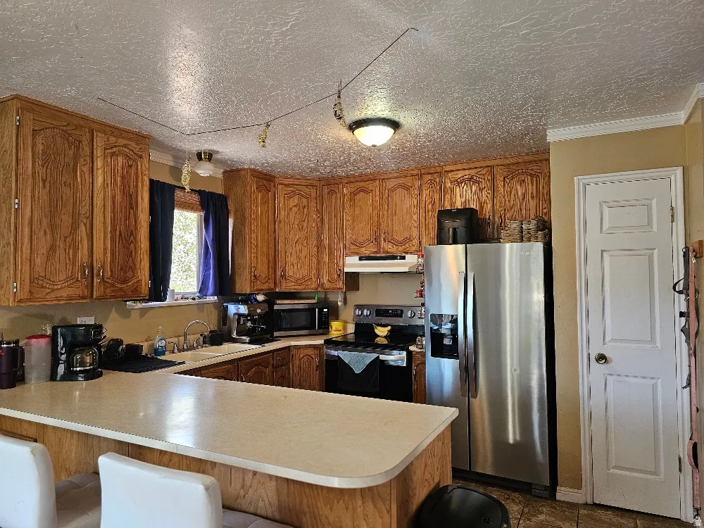 Kitchen featuring wood cabinetry, stainless steel appliances, and a light-toned countertop
