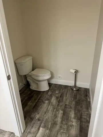 Recessed water closet featuring Vinyl flooring