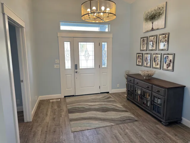 Double entry doors with decorative glass panels, transom window, and Vinyl flooring