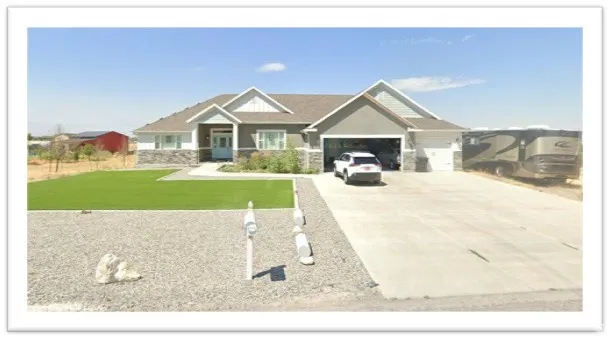 Single-story residence featuring a stone and siding exterior, front-facing two-car garage, and an additional single-car garage
