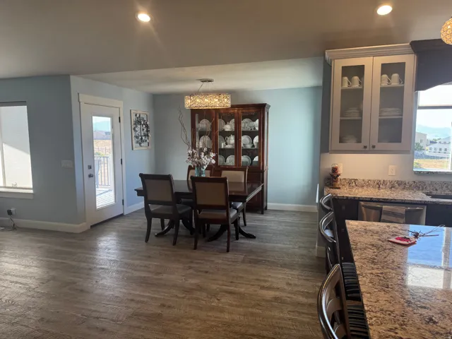 Vinyl flooring throughout, recessed lighting, and a glass-paneled exterior door