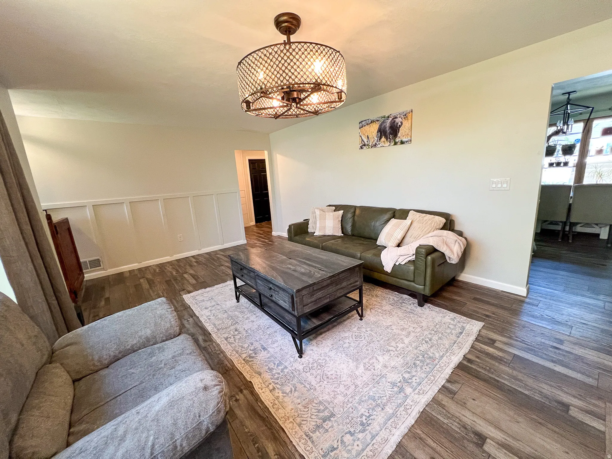 Wood-finish flooring, wainscoting, and an open-concept layout