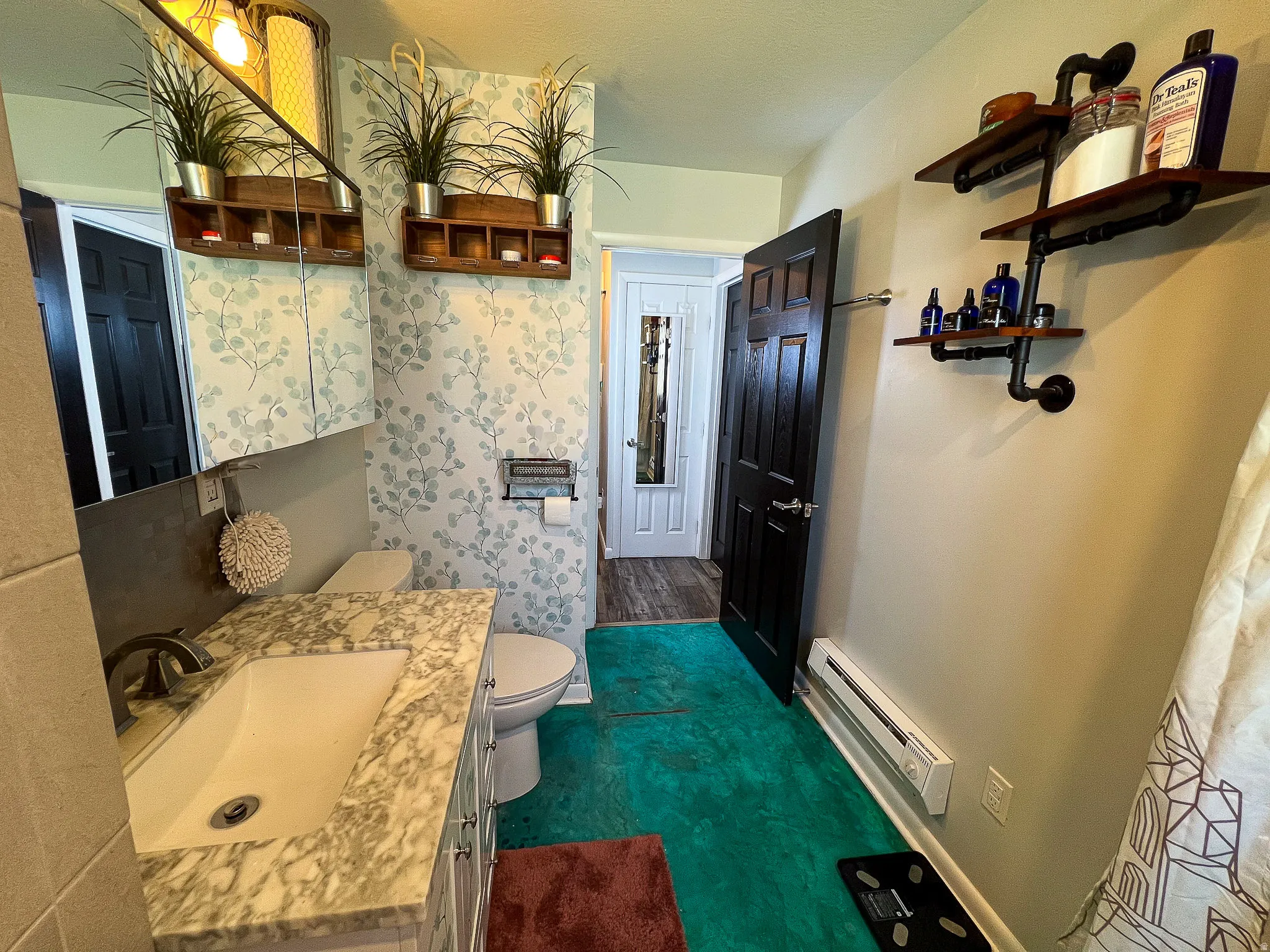 Vanity with a solid surface countertop, undermount sink, and wall-mounted mirror