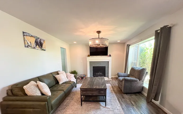 Fireplace with a patterned tile surround and a white mantel