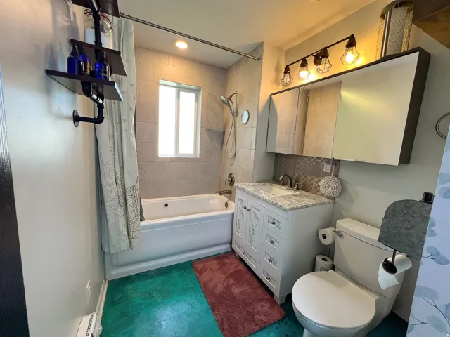 Modern vanity with white cabinetry, a light-toned countertop, and an undermount sink