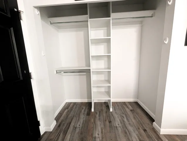 Built-in closet system with multiple shelving units and hanging rods