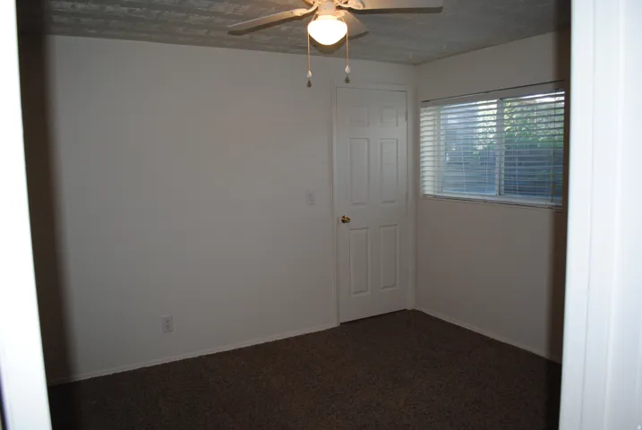 White interior walls with wall-to-wall carpeting