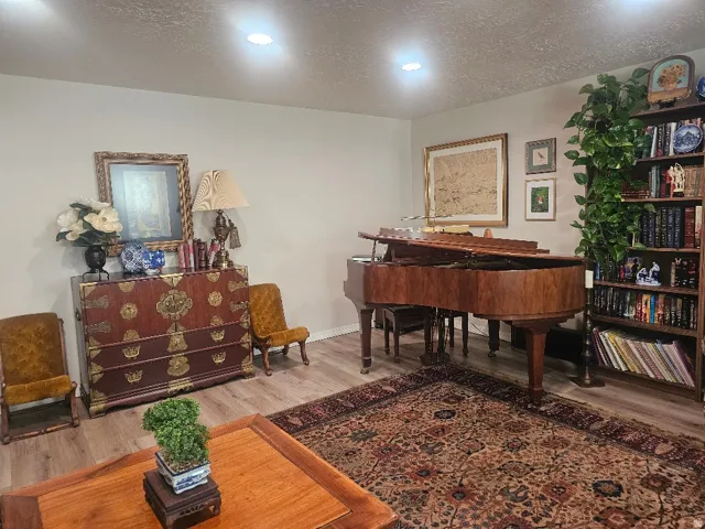 Recessed ceiling lighting, wood-finish flooring, and light-toned wall paint