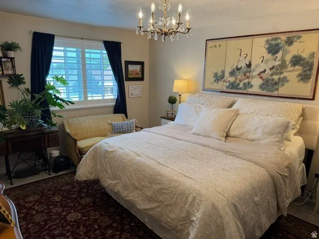 Recessed window featuring white louvered shutters and dark curtains