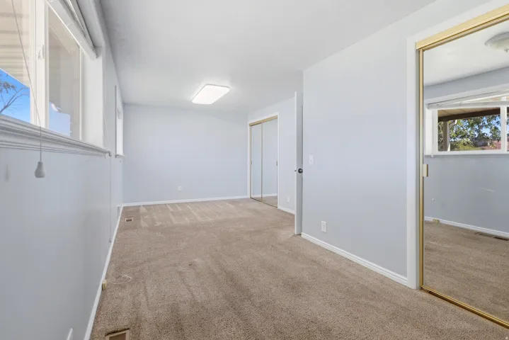 Wall-to-wall carpeting and a ceiling-mounted light fixture