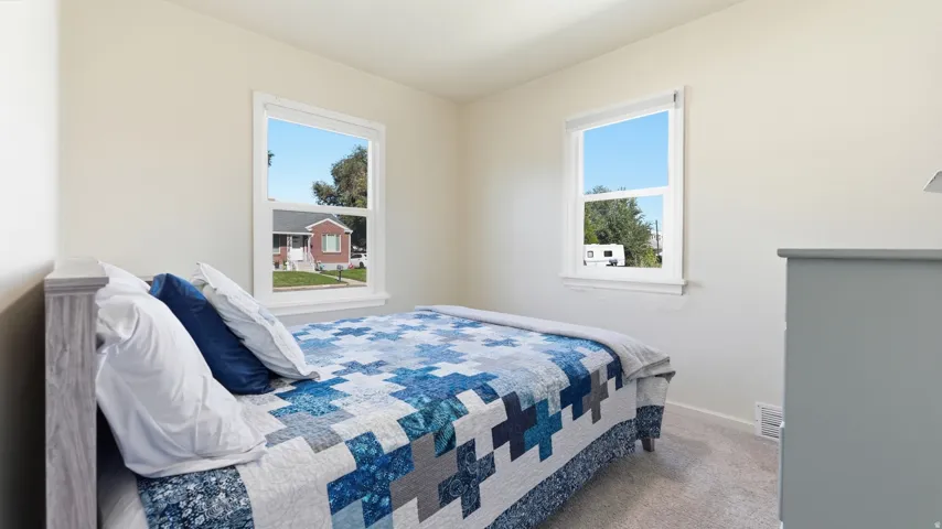 Neutral wall finishes, dual windows, and light-colored carpeting