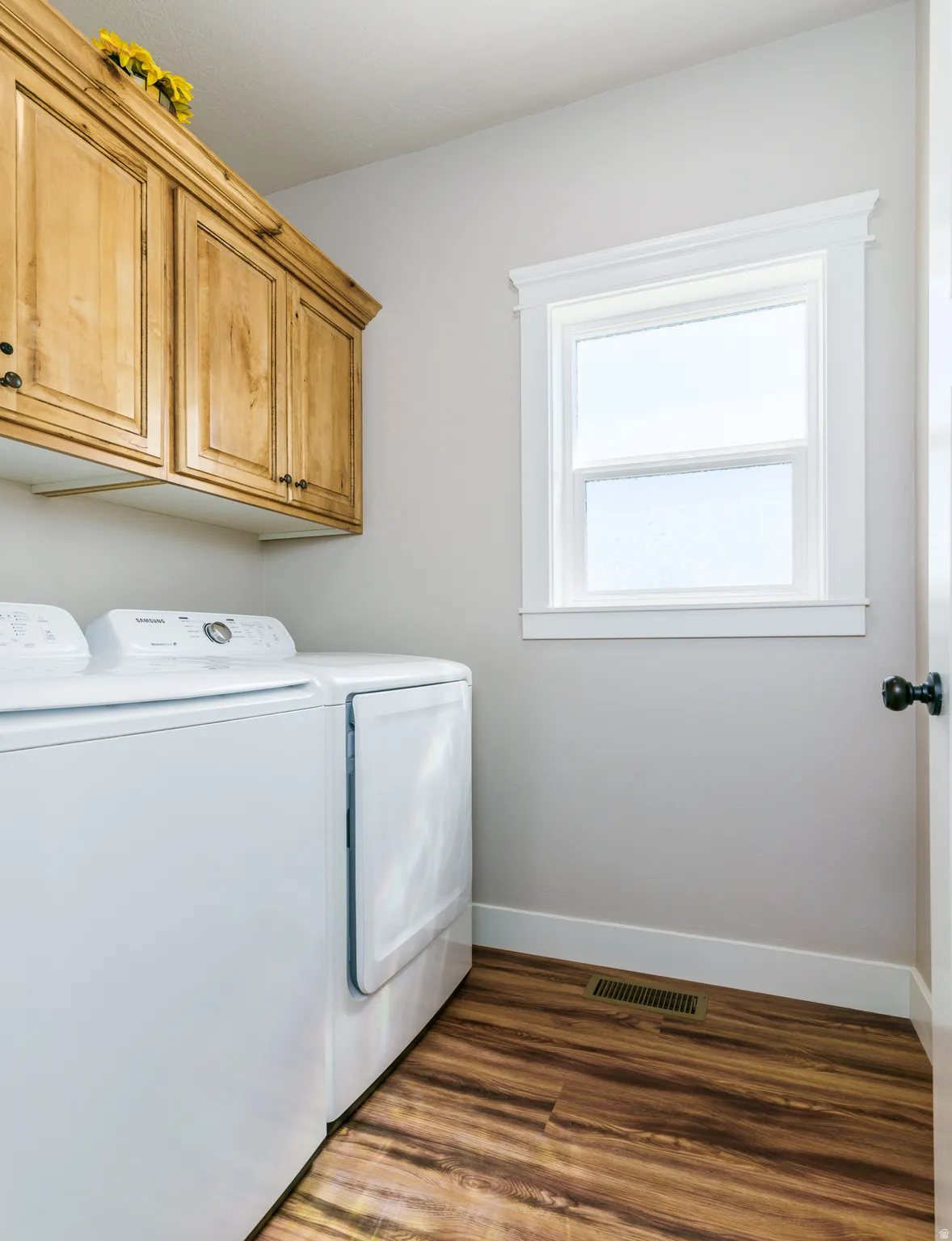 Warm wood-finish flooring complements the light wall color